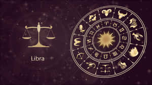 黃道輪及天秤座符號以金色呈現，背景為星光點點的紫色。 — 天秤座 壁紙