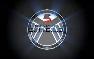 深色背景上帶有藍色光線的閃亮 S.H.I.E.L.D. 標誌。 — 寶可夢 剑 盾 壁紙