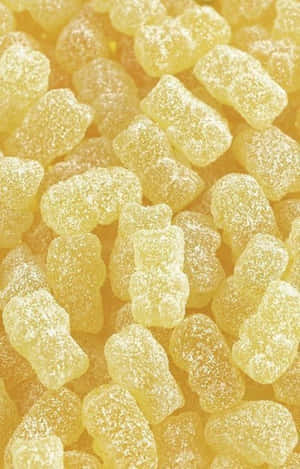 覆蓋著糖晶體的黃色軟糖熊。 — 甜食控 壁紙