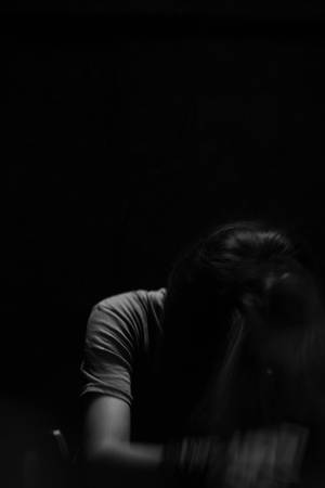 剪影中的人在昏暗光線下向前傾。 — 昏暗 壁紙