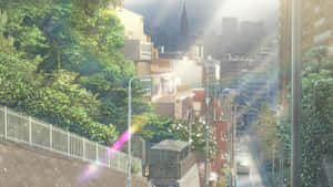 陽光明媚的城市街道，綠樹成蔭，遠處有摩天大樓。 — 天氣之子 壁紙