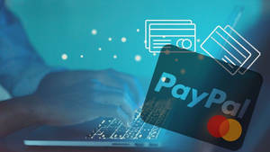 人在筆記型電腦上打字，PayPal和信用卡圖示漂浮在周圍。 — PayPal 壁紙