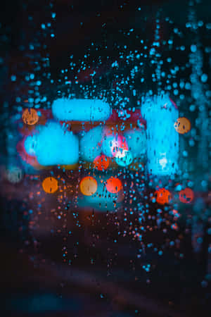 夜間窗戶上的雨滴與模糊的城市燈光 — Huawei MatePad Air (2026) 壁紙