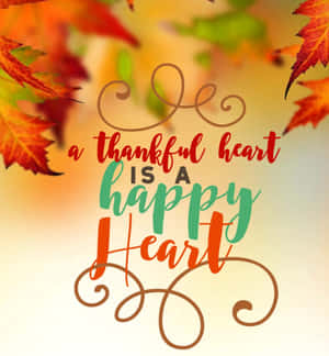 秋葉以彩色手寫體框住了「a thankful heart is a happy heart」這句話。 — 榮耀Magic V 壁紙