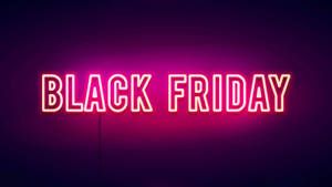 寫著 Black Friday 的霓虹燈牌在深色背景上發出粉紅色光芒。 — 黑色星期五 壁紙