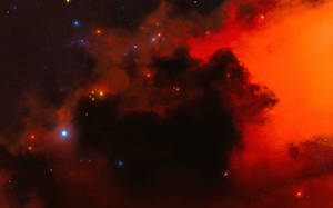 在深空中帶有發光恆星的戲劇性紅色和橙色星雲。 — 16:10 壁紙
