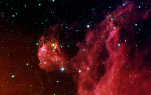 一個發光的紅色和藍綠色星雲，充滿了深空中的明亮星星。 — 宇宙美學 壁紙