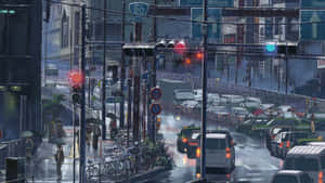 黃昏時分下雨的東京街道，閃爍的交通燈和撐傘的行人。 — 新海誠 壁紙