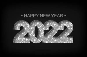 黑色背景上以銀色閃亮文字顯示Happy New Year 2022。 — 新年快樂 2020 壁紙