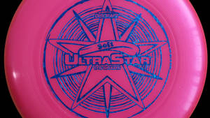 粉紅色Discraft UltraStar飛盤，帶藍色星星設計 — 終極飛盤 壁紙